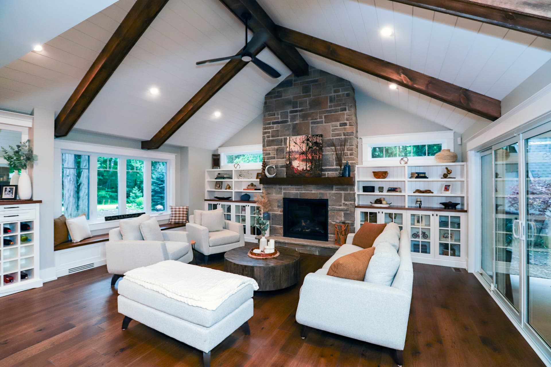 Vaulted living room with exposed beams and stone fireplace